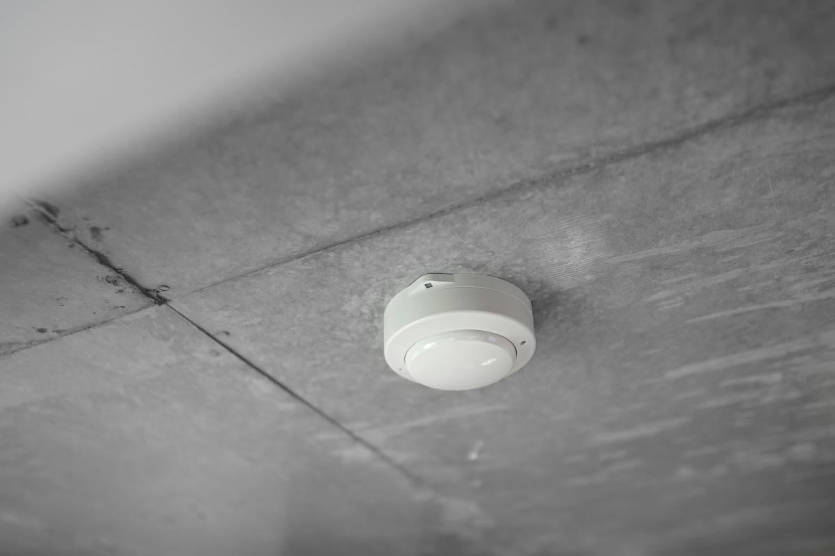 Ceiling smoke detector on a concrete soffit