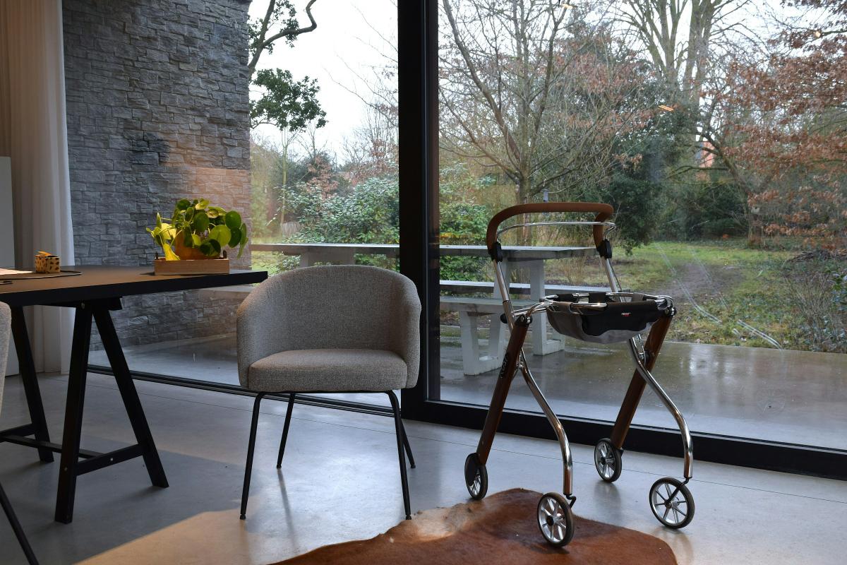 Care home lounge with a walking frame by the window